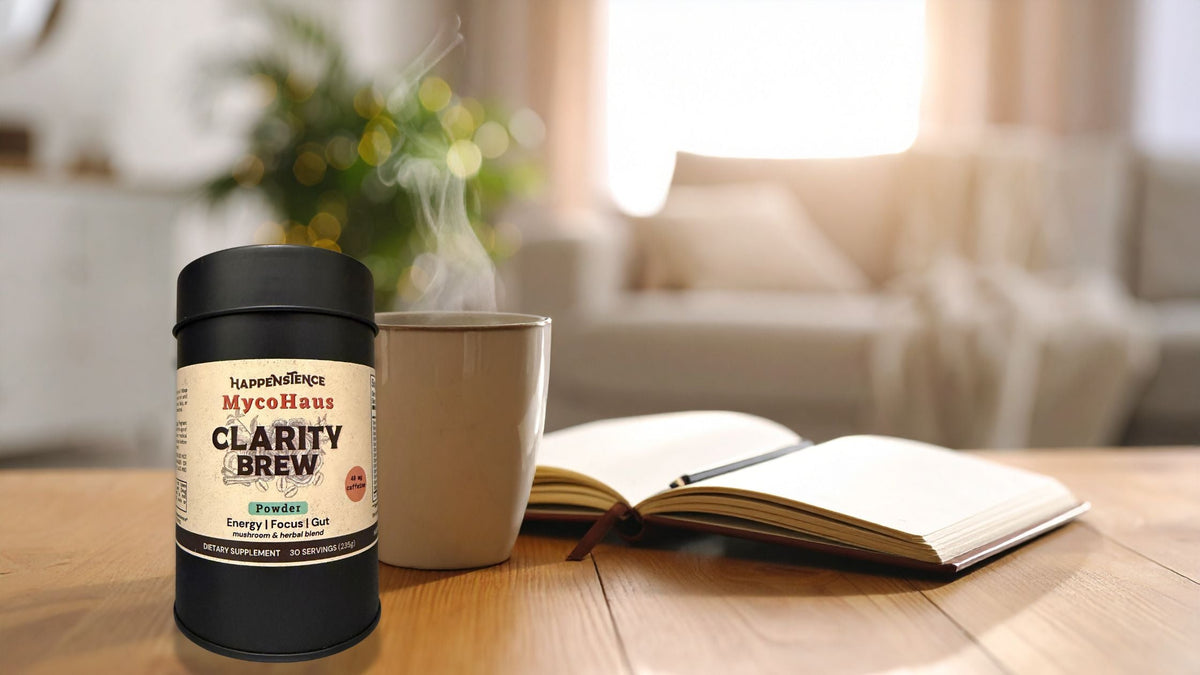 Happenstence Clarity Brew next to a steaming mug and open journal