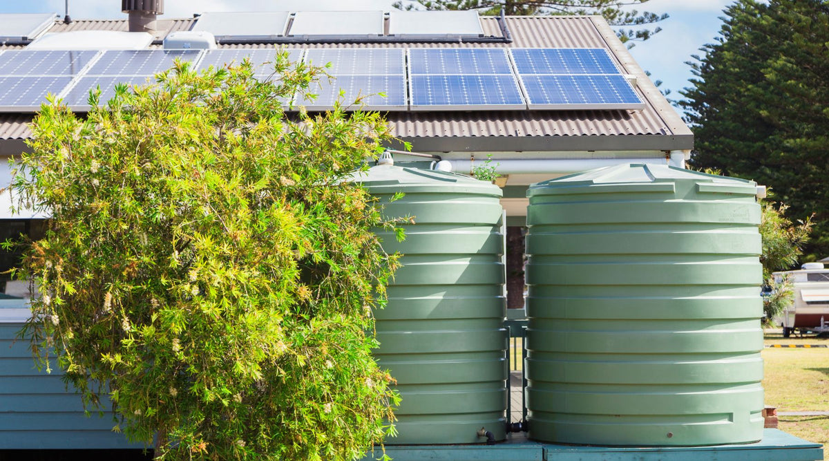 Rainwater Barrels next to a sloped barn roof