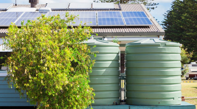 Rainwater Barrels next to a sloped barn roof