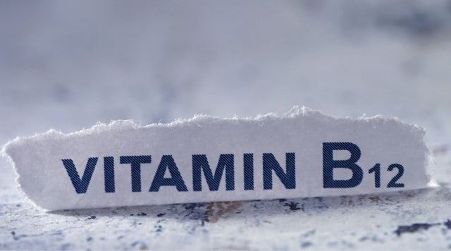 Vitamin B12 on a torn sheet of paper on a countertop