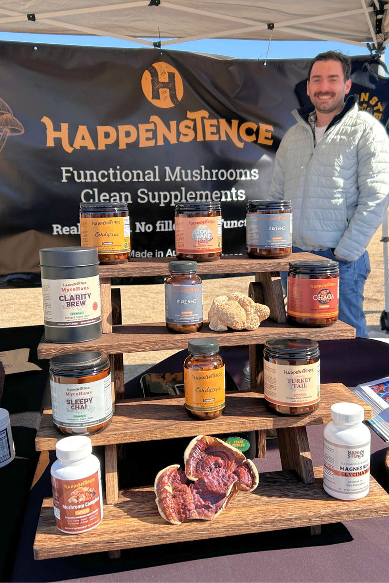 Happenstence booth with mushroom supplement products at an outdoor event