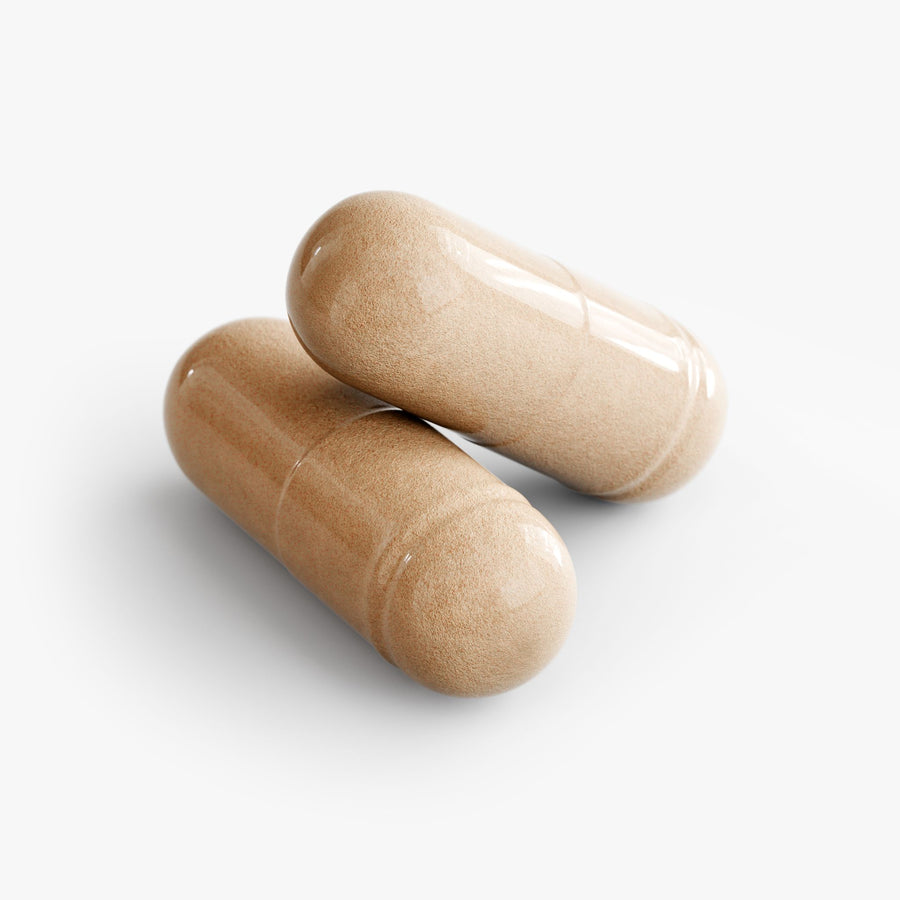 Two beige mushroom complex capsules on a white background